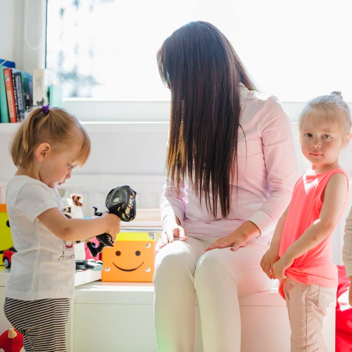 children posing with babysitter