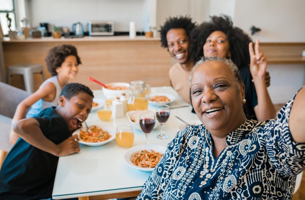 portrait african american multigenerational family taking selfie together while having dinner home 1